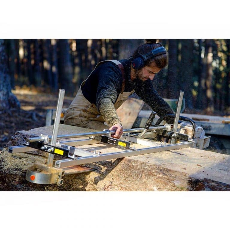 A man with ear muffs finishing a log using Granberg's Equipment - 2